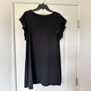 This is a Nik and Ash black sheath dress with ruffle sleeves.